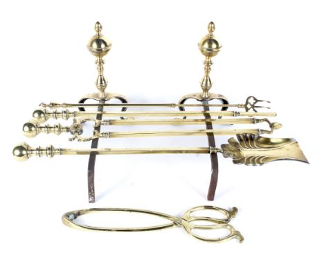 A set of 19th century brass firedogs and a fire companion set. The firedogs with ball finials on cabriole legs and pad feet, 