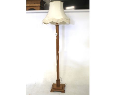 An Art Deco blond oak standard lamp with shade. On a square base and square feet, H153cm 