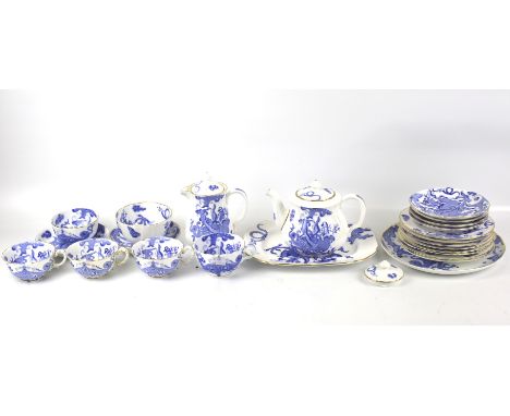 A Royal Worcester four-piece tea service in the 'Dragon' pattern. Including a teapot, cups and saucers, plates, milk hug, bow