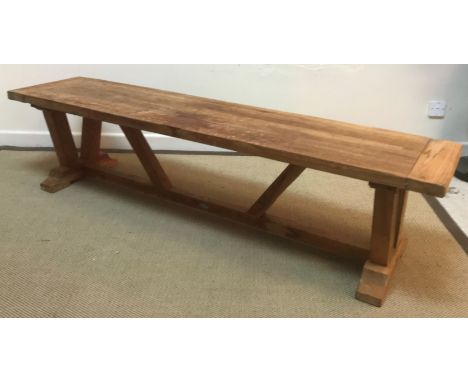 An elm refectory style kitchen table on plank,end supports united by a central stretcher 142 cm long x 67 cm wide x 75 cm hig