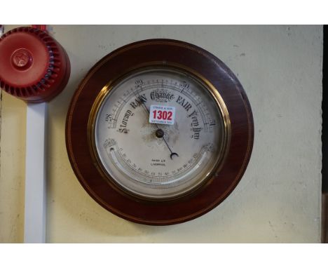 A mahogany framed aneroid barometer, the silvered dial inscribed 'Haigh Ltd, Liverpool', 24cm diameter. 