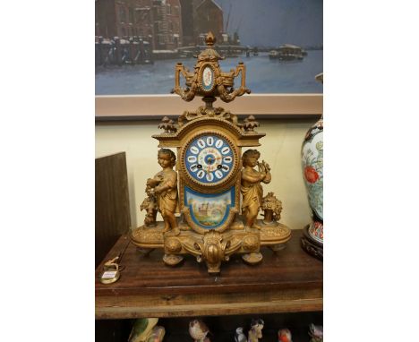A late 19th century gilt metal and Sevres style mantel clock, 46cm high, with pendulum. 