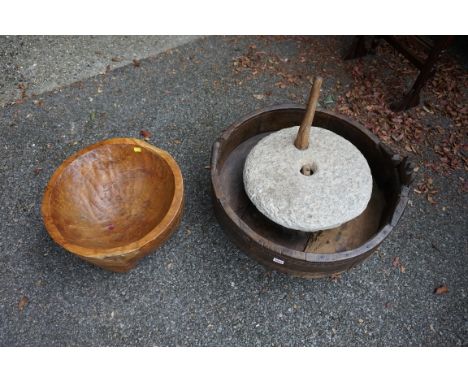 An old corn grinder; together with a wooden bowl.&nbsp; 
