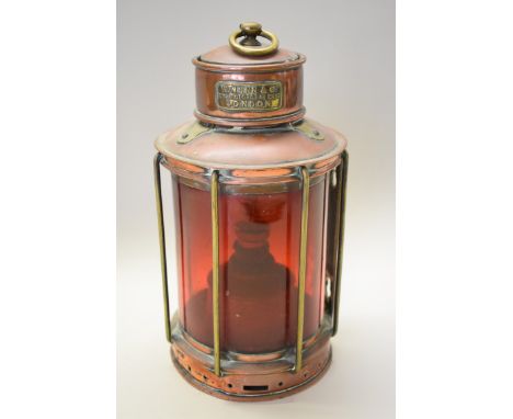 A Victorian copper and brass lantern, labelled 'W Nunn &amp; Co, 204 St George St East, London', with red glass shade, height