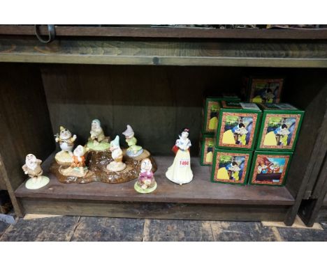 A set of eight Royal Doulton 'Snow White and The Seven Dwarfs' figures,&nbsp;each boxed; together with an associated Beswick 