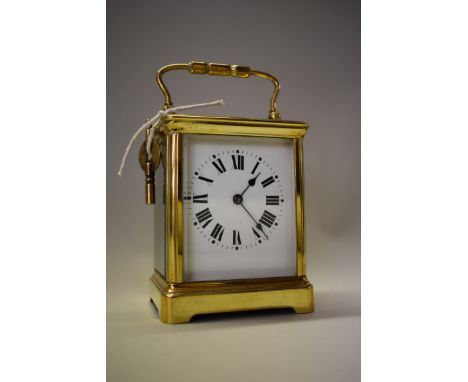 An antique brass carriage clock,&nbsp;striking on a gong, height including handle, 16.5cm, with winding key. 