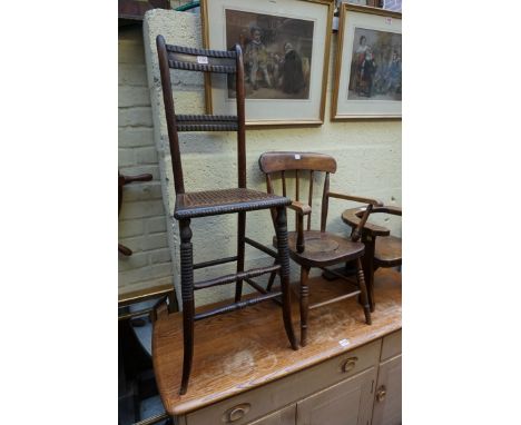 A 19th century beech child's correction chair, with cane seat; together with another 19th century elm and beech child's commo