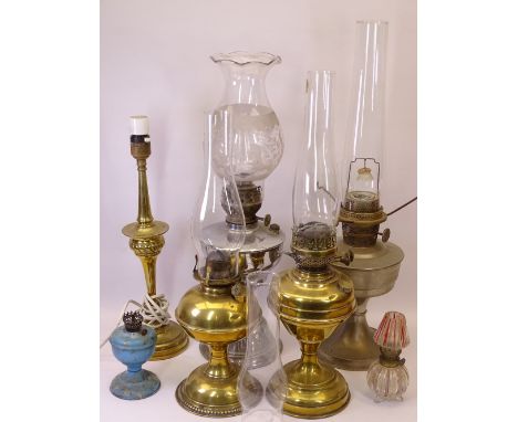 OIL LAMPS &amp; LIGHTING an assortment with accompanying chimneys and an etched glass shade