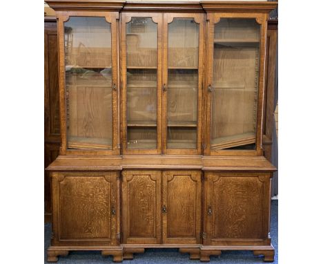 LATE 19th CENTURY INVERTED BOOKCASE CUPBOARD, two piece, the upper section with four long glazed doors with adjustable shelve
