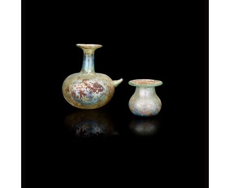 TWO ROMAN GLASS BEAKERS 3RD CENTURY A. D. the first with a flared rim and ring base, with several faintly incised continuous