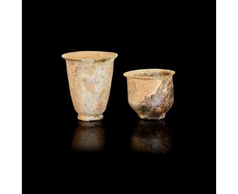  TWO ROMAN GLASS VESSELS CA 2ND CENTURY A. D. the first a pourer with a squat bulbous body with a tapering feeding spout to o