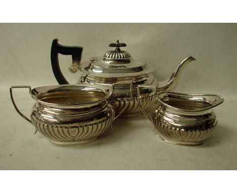 A George V three-piece silver Tea Service by Viners Ltd, reeded oval shape with ebonised knop and handle to teapot, 42.65oz t