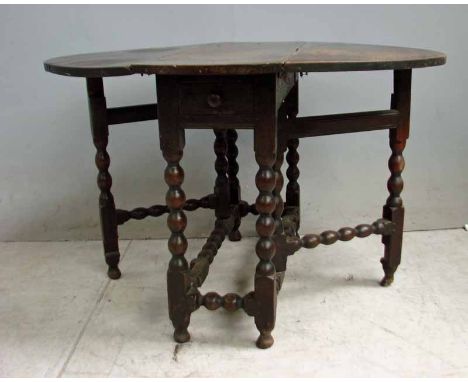 An 18th century Joint Drop Leaf Dining Table of smaller proportions, hinged oval top, single frieze drawer, bobbin turned bas