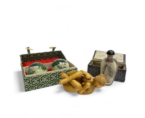 3 items to include  - Japanese carved wood figurine of a nude lady, 8cm Long.   - 2 painted glass musical balls in box  - A E