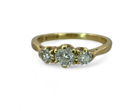 An estimated 0.40ct 18ct gold diamond three stone ring. Featuring a central round brilliant cut stone of an estimated 0.20 ca