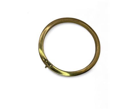 A "9k" stamped hollow hinged bangle, testing as 9K yellow gold.
In good condition, free from dents with box clasp and a singl