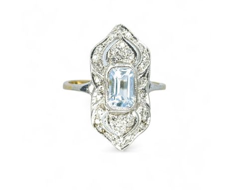 A 9ct gold topaz and diamond panel ring in the Art Deco style. Featuring a central emerald step cut, pale blue topaz, surroun