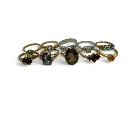 A collection of 9 gem set rings in hallmarked gold, together with a 9ct gold band ring.
Comprising: a 9ct gold Rose de France