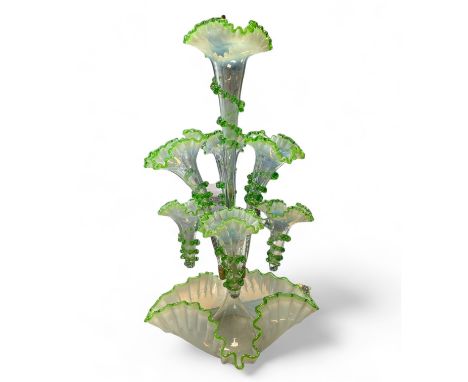 A Vaseline glass epergne with seven branches. Approximate total height 56cm. Overall generally good, some small chipping to o