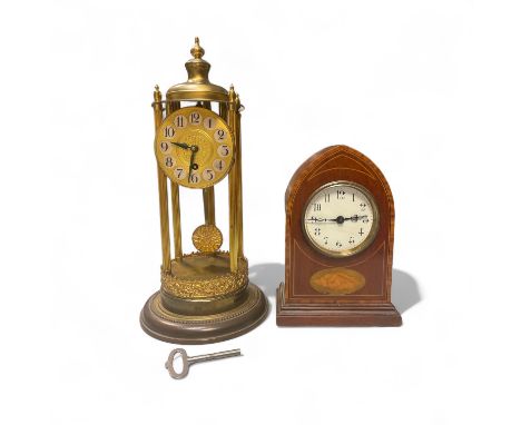 A Brass pillar clock under a glass dome, Approximately 15cm x 37cm And a Mahogany lancet clock Approximately 16cm x 8cm x 23c