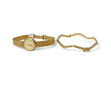 A 9ct yellow gold wave form bangle along with a 9ct yellow gold Rodania ladies cocktail watch on a 9ct bracelet.  The bangle 
