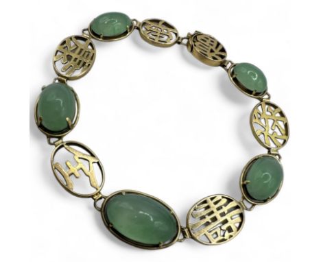 A translucent green jadeite set bracelet, featuring Chinese characters. Stamped "14k" and testing accordingly. With a box cla