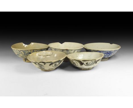 Ming Dynasty, 1368-1644 AD. A mixed group of glazed ceramic bowls and dishes with blue tendril ornament.  1.36 kg total, 14-1