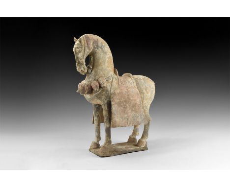 An undated archaistic ceramic figure of a horse standing on a small square base in Northern Qi style; neck arched and head he