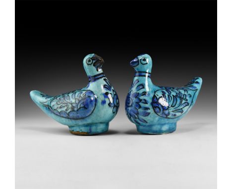 An undated archaistic pair of hollow-formed blue-glazed ceramic birds with floral detailing to the chest and wings.  841 gram
