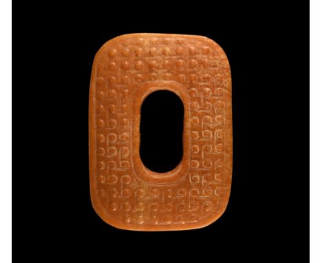 19th-20th century AD. A jade sword slide of rounded rectangular shape with an oval aperture to the centre; carved with spiral