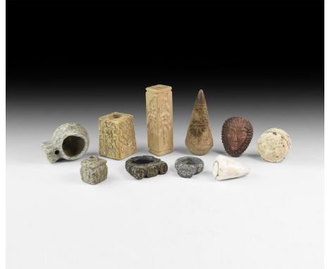 An undated archaistic group comprising: two stone rings; a bifacial limestone seal; an agate mask plaque; a schist miniature 