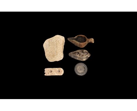 An undated archaistic group of stone items comprising: an oil lamp with bird-head handle; an oil lamp with scrolled tendrils 