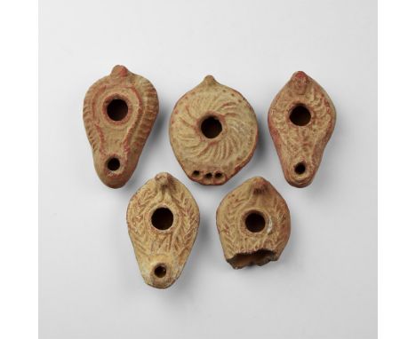 A group of five undated archaistic ceramic discoid and slipper-shaped oil lamps with geometric detailing.  381 grams total, 6