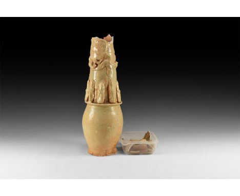 Song Dynasty, 960-1127 AD. A fragmentary cream-glazed ceramic granary jar with dragon and rosette appliqués to the neck above