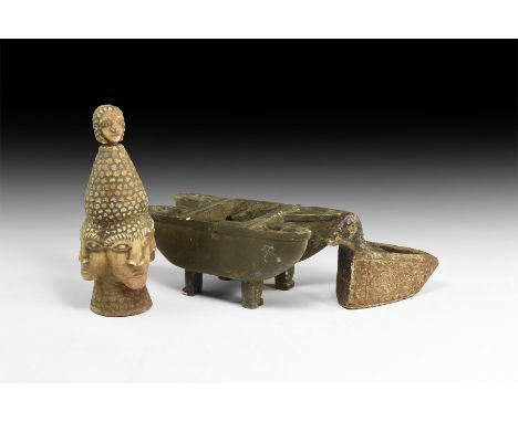 A mixed group of undated archaistic stone items comprising a narrow oil lamp with duck-head handle, a finial with four radiat