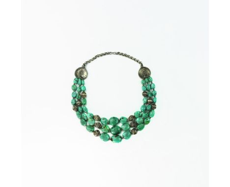 20th century AD. A necklace of graduated irregular turquoise(?) beads in three tiers with base metal melon beads, heart-shape
