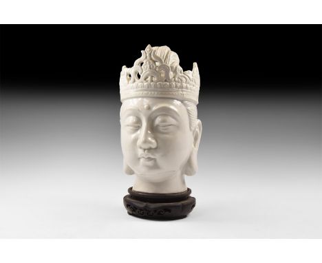 20th century AD. A hollow-formed white glazed ceramic head of Arya Tara with bound hair piled on top of the head, crown with 