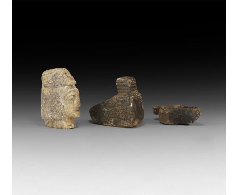 An undated archaistic group of carved stone items comprising: an oil lamp with piriform body and lug handle; an oil lamp with