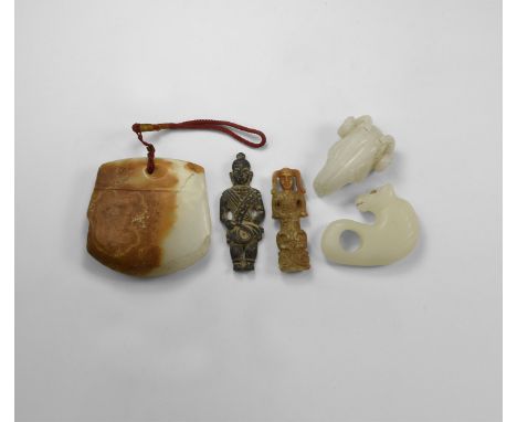 An undated archaistic group of carved stone items comprising: a jade hand-axe pendant; a ram's head pendant; a pendant with r