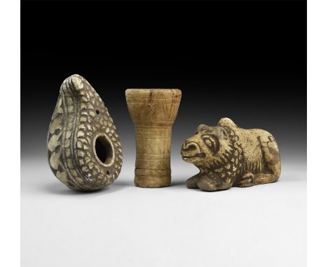 An undated archaistic group of carved stone items comprising: a figure of a lion resting; a leaf-shaped oil lamp; a tubular h