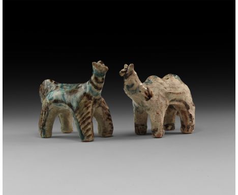 An undated archaistic pair of ceramic animal figurines, both with polychrome ornament, one with pinched lateral ledges for pa