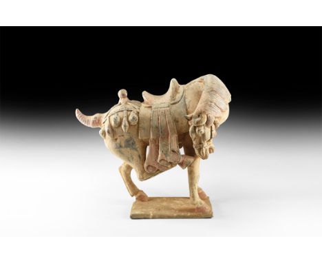 An undated archaistic large ceramic figure of a horse with head turned back and right hind leg stretched forward in Northern 
