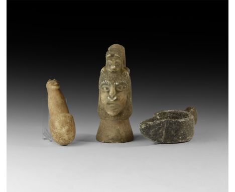 An undated archaistic group of carved stone items comprising: a pestle with beast-head finial; a mortar with bird-head lug ha