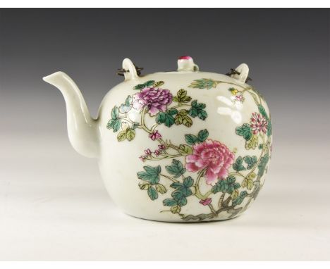 20th century AD. A white glazed ceramic teapot with chrysanthemum design, lid with apple-shaped knop handle, chop seal to the