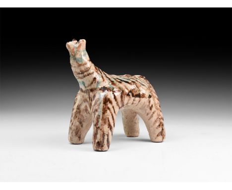 An undated archaistic glazed ceramic figure of a standing beast with polychrome markings.  439 grams, 13cm (5"). Property of 