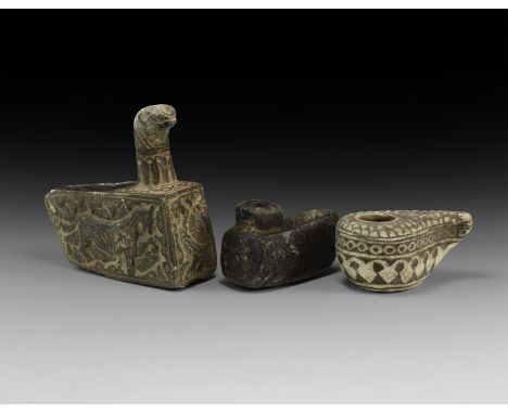 An undated archaistic group of carved stone items comprising: a leaf-shaped oil lamp; a wedge-shaped lamp with rectangular fi