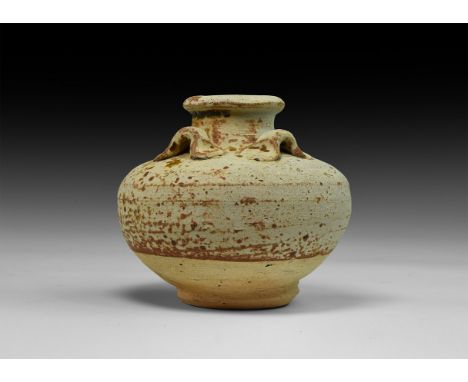 15th-16th century AD. A ceramic vessel with discoid base, squat bulbous body and flared lip; four lug handles to the shoulder