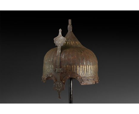 Late 19th-20th century AD. An iron helmet with ribbed dome, spike with polyhedral bulb and inlaid calligraphic text to the ba