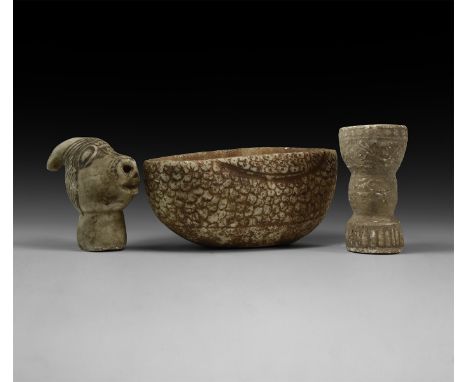 An undated archaistic group of carved stone items comprising: a vessel with scale detailing to the outer face; a bovine head;