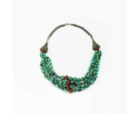 20th century AD. A necklace of graduated irregular turquoise(?) beads in four tiers with base metal beads and amber(?) melon 